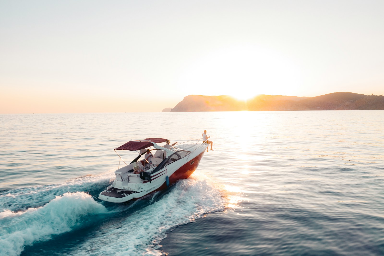 man riding on white and red boat on sea during daytime, boat